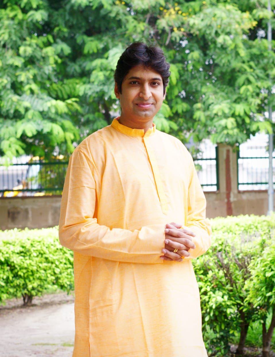 Welcoming outdoor portrait of Dr. Koustubh Pare in a garden