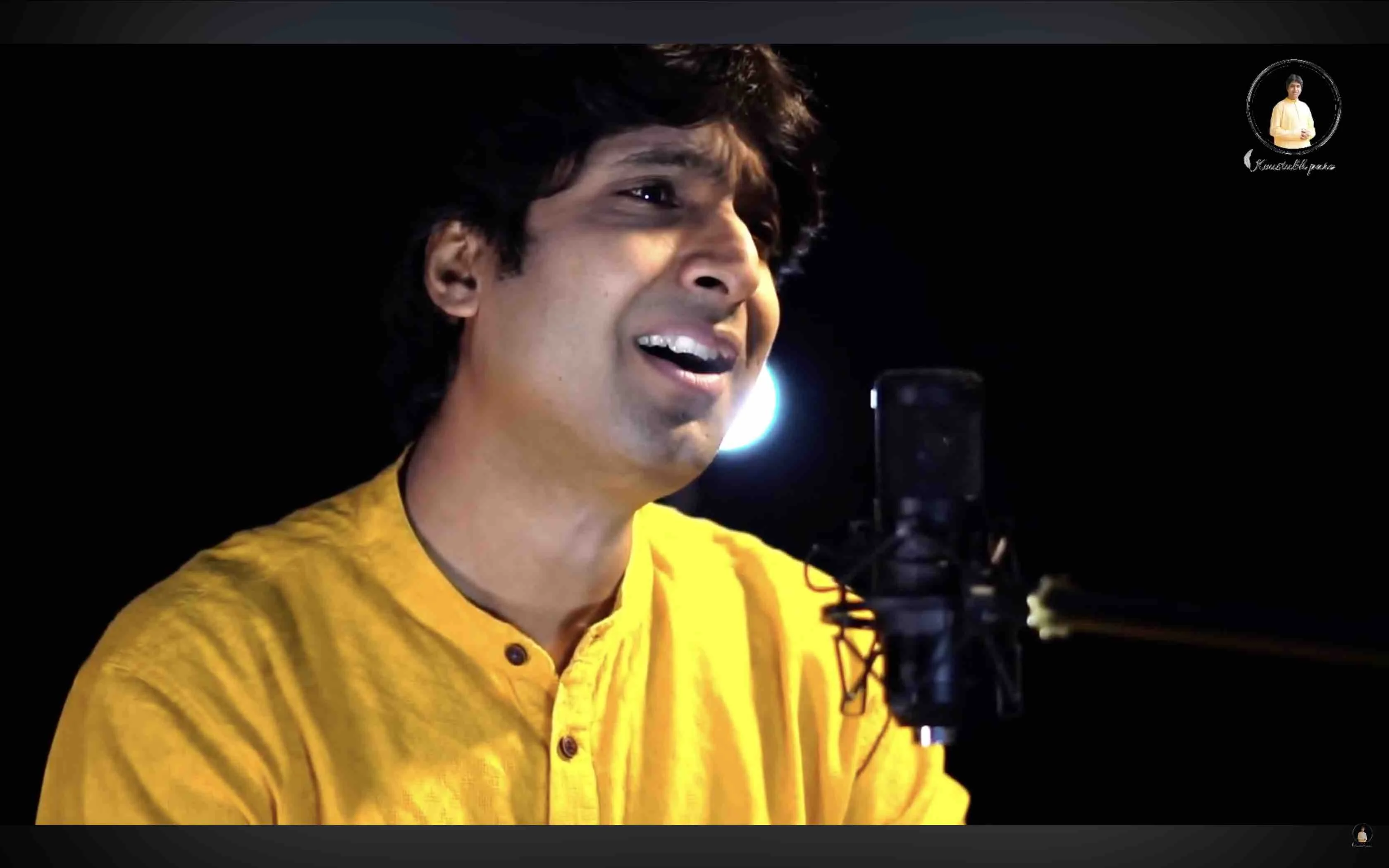 Dr. Koustubh Pare singing with an expressive hand gesture during a classical recital